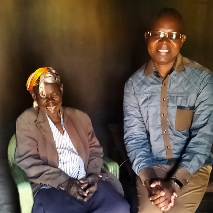 An older community member together with a representative of Reborn Foundation Kenya